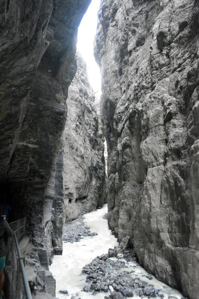 narrow gorge with a river flowing between vertical cliffs