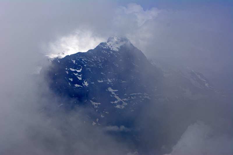 Eiger mountain peeping through dense clouds