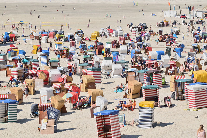 holiday makers in the sun on the beach