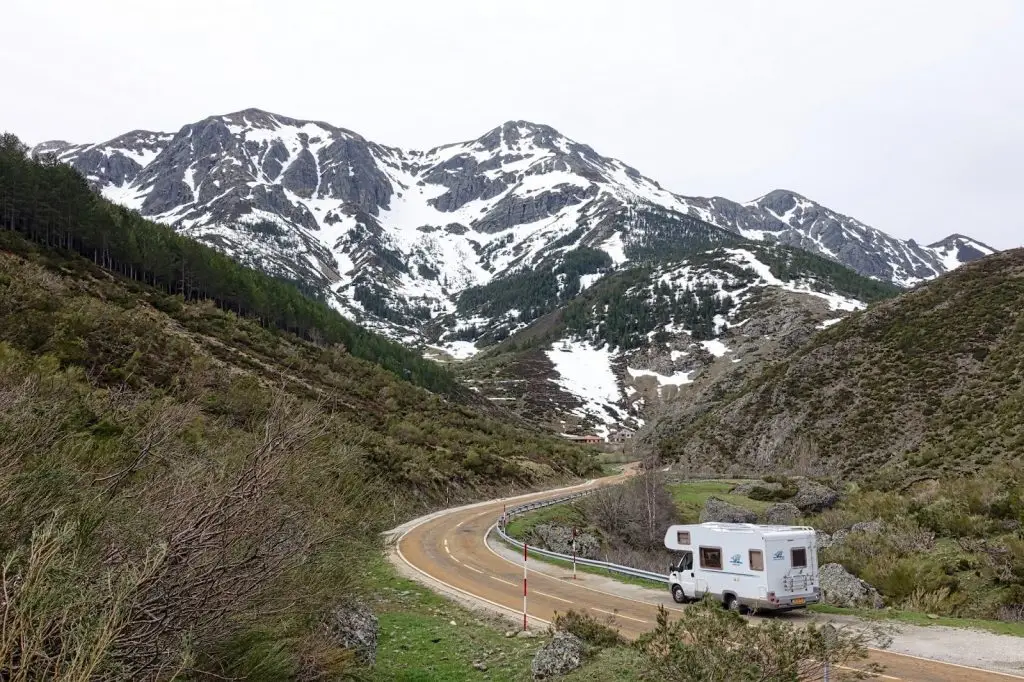 mobile home on a bend in the road in mountains
